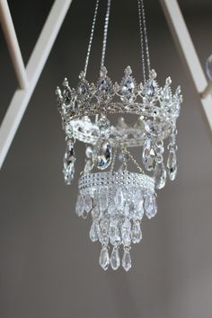 a crystal chandelier hanging from a white ceiling