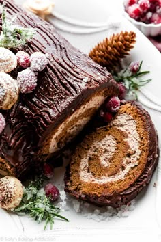 a chocolate cake with powdered sugar and cranberry toppings on a white plate