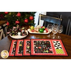 a christmas table setting with wine glasses and plates