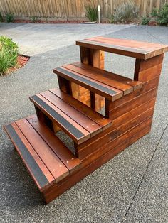 a wooden bench sitting on top of a sidewalk