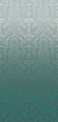 a green and white wallpaper with an intricate design on it's side,