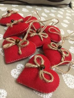 red heart shaped ornaments are tied with twine