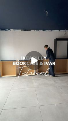 a man standing in front of a bookcase and tv on top of a tiled floor