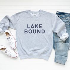 Lake bound this summer? Our cozy sweatshirts are perfect for cool summer nights and fall days spent lakeside. They make great gifts for hikers, campers, adventure and nature lovers! Ideal for any situation, a unisex heavy blend crewneck sweatshirt is pure comfort. These garments are made from polyester and cotton. This combination helps designs come out looking fresh and beautiful. The collar is ribbed knit, so it retains its shape even after washing. There are no itchy side seams on these sweat Lake Clothes, Gifts For Hikers, Monogram Outfit, Lake Girl, Camper Shirt, Lover Sweatshirt, Cool Summer, Lake Life, Mom Outfits