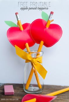 two paper hearts in a jar with pencils