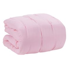 the pink comforter is folded up on top of the bedding and it has two pillows