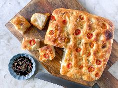 a wooden cutting board topped with cheese and pepperoni