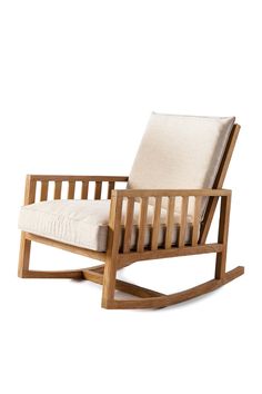 a wooden rocking chair with a white cushion