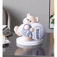 a white bear figurine sitting on top of a desk