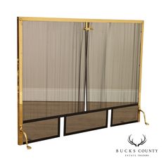 the back side of a double door with mesh panels and brass hardware on each side