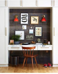 a white desk with some pictures on the wall