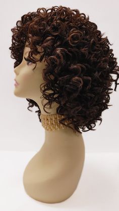 "Stylish wig featuring defined spiral curls and bangs. Inside cap has no combs and adjustable elastic straps. Heat-resistant up to 350F. Color: Dark Brown with Copper Highlights (4/30) Style: 10 inches and Curly. Circumference: Default at 21\" with adjustable cap (max 22\") Materials: Premium Heat Resistant Synthetic Wig Fiber All sales are final. Please read all store policies before purchasing." Dark Brown With Copper Highlights, Brown With Copper Highlights, Dark Brown With Copper, Curls And Bangs, 3b Curly Hair, Curly Wig With Bangs, Copper Highlights, Spiral Curls, Curly Hair Wig