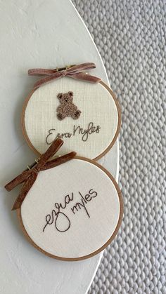 two embroidered teddy bears are sitting next to each other on a white surface with the words enjoy my hugs written in cursive writing