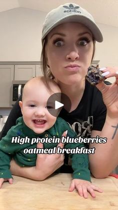 a woman is holding a baby in her arms and the caption reads, high protein blueberries oatmeal breakfast