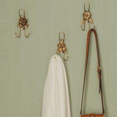 the coat rack has two hooks on it