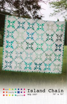 the island chain quilt pattern is displayed in front of a green field with trees and grass