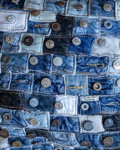 several different types of buttons are in the back pocket of a pair of blue jeans