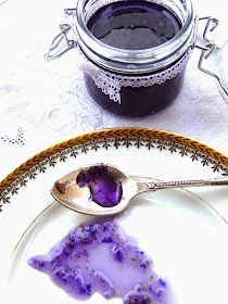 a plate topped with a piece of cake next to a jar of jelly