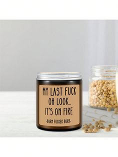 a jar of soy beans next to a glass container with the words, my last fuk oh look it's on fire