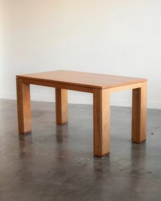 a wooden table sitting on top of a cement floor