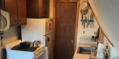 a small kitchen with an oven, refrigerator and stove in it's center area