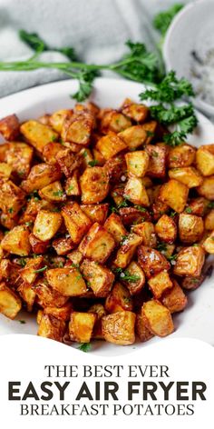 the best ever easy air fryer breakfast potatoes on a white plate with parsley