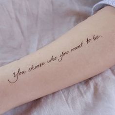 a person with a tattoo on their arm that says, you choose what to be