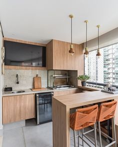 a kitchen with wooden cabinets and stools next to a counter top that has an oven on it