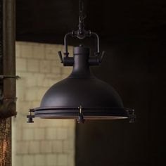 an industrial light hanging from the ceiling