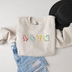 Bring a touch of nostalgia to your wardrobe with this Embroidered Vintage Cartoon Sweatshirt! Perfect for fans of classic cartoons, this retro-inspired crewneck features your favorite characters like Pikachu, Squirtle, Bulbasaur, and Charmander. The detailed embroidery adds a unique, stylish touch, making this sweatshirt a must-have for both casual wear and collector's items. Ideal as a gift for him, this cozy pullover is made from premium fabric, ensuring comfort and durability. Whether you're Embroidered Pokemon, Pokemon Silhouette, Pokemon Shirt, Casual Luxe, Vintage Cartoons, Sweatshirt Trendy, Cartoon Sweatshirts, Cozy Pullover, Pokemon Characters