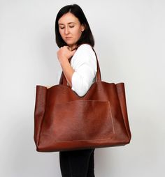 "Cognac brown leather tote - large leather tote bag This brown large tote bag is made from high quality italian leather. Spacious interior provides room for all the daily essentials and more. There is an inside zippered pocket. This bag is perfect as your everyday bag, which can fit an IPAD, A4 files, books, magazines, cosmetic bag as well as many accessories. Additional large slip pocket at the front of the bag. Height: 39 cm / 15.4\" Max width at the top: 61 cm / 24\" Width at the base: 51 cm Brown Rectangular Weekender Bag, Rectangular Brown Weekender Bag For On-the-go, Large Brown Satchel For Daily Use, Brown Rectangular Weekender Bag For Everyday Use, Rectangular Brown Weekender Bag For Everyday Use, Brown Large Capacity Weekender Bag For Everyday, Large Brown Rectangular Satchel, Large Rectangular Brown Satchel, Brown Large Capacity Weekender Bag