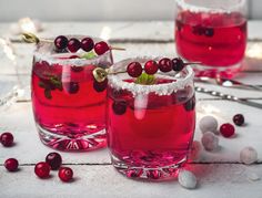 two glasses filled with cranberry punch on top of a table