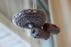 a crocheted teddy bear hanging from a string