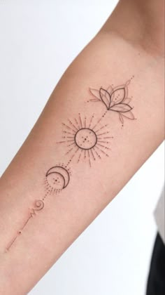 a woman's arm with the sun and moon tattoos on it