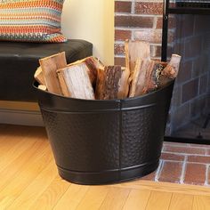 a fire place with logs in it next to a fireplace