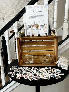 a table with some pictures on top of it next to a stair case and stairs