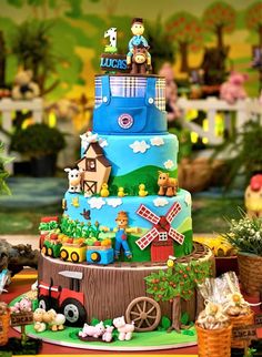 a multi layered cake decorated with farm animals and farmer's life scenes on it