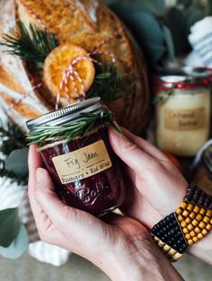 a person holding a jar of jam in their hands