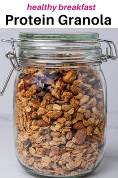 a glass jar filled with granola on top of a table