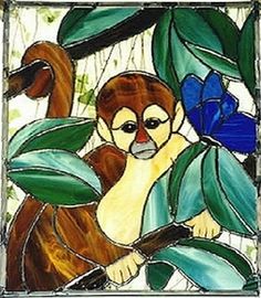 a stained glass window with a monkey on it's back and blue flowers in the background