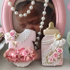 the baby shower products are being displayed in front of a pink frame with flowers and pearls