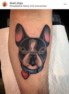 a dog with a heart tattoo on his leg