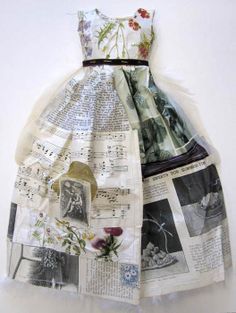 a dress made out of newspaper with flowers on it