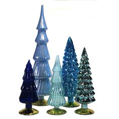 four different colored glass christmas trees on gold bases, all in various sizes and shapes