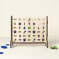 a wooden toy with blue and green letters on it