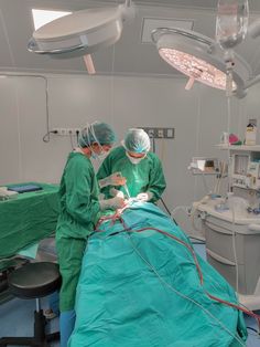 two doctors performing surgery in an operating room