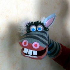 a stuffed animal that looks like a zebra with its mouth open and teeth wide open