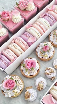 there are many pink and white desserts in the box