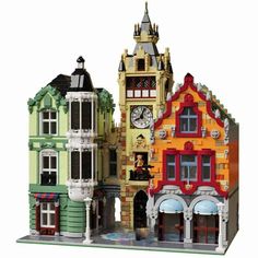 two buildings made out of legos with a clock on the front and side of each building