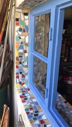 the window is made out of colorful glass and has many different colored tiles on it